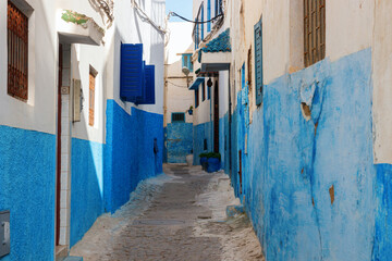 Old, narrow street in the Kasbah of the Udayas with blue and white painted houses. The Kasbah of the Udayas is a major tourist attraction of Rabat. Morocco.