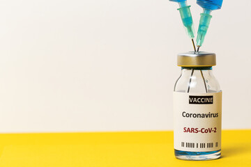Transparent glass vials with test COVID-19 vaccine, with syringes