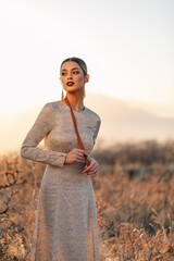 Model shoot in mountains. Brown, gray, orange color palette. 