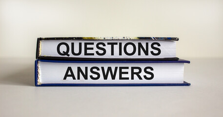 Questions and answers symbol. Concept words 'questions and answers' on books on a beautiful white background. Business and questions and answers concept. Copy space.