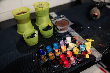 Close-up of tattoo pigment of different colors in boxes into needles