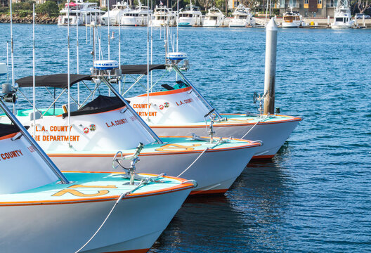 three Los Angeles County Baywatch lifeguard boats at dock in Marina Del Rey, California