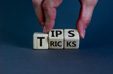 Tips and tricks symbol. Businessman turns cubes and changes the word 'tricks' to 'tips'. Beautiful...