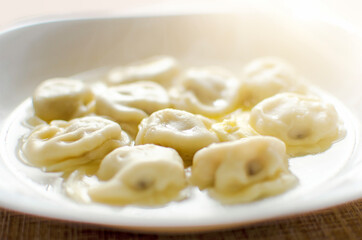 Homemade dumplings stuffed with meat in a white plate. Russian food.