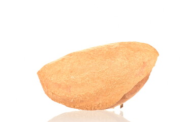 One organic unpeeled almond nut, close-up, isolated on white.