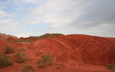 Aktau Mountains on sunrise. Beautiful landscape of colorful mountains in desert. Nature reserve Altyn Emel. Kazakhstan