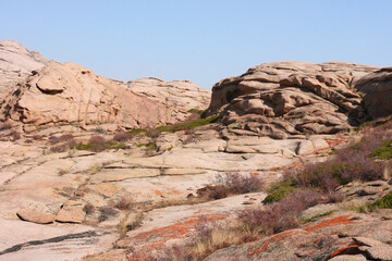 Bektau-Ata Tract. Bektau mountains. Rock formations in Bektau Ata in Kazakhstan in summer. Desert mountains Bektau-Ata. Focus on mountains. Landscape of the gorge and rocks. 