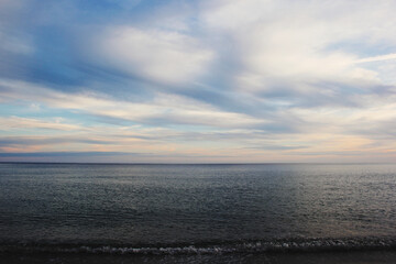 Fototapeta premium horizon, sea at sunset with blue sky and clouds