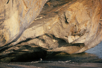 rock illuminated by the sunset light over the sea
