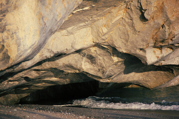 rock illuminated by the sunset light over the sea