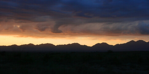 Beautiful summer sunset dramatic sky in Kazakhstan mountains. National park. Banner size with copy space.