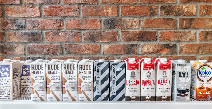 Row of milk alternatives / plant milk cartons, of various brands available in the UK. London / UK - June 15th 2019 