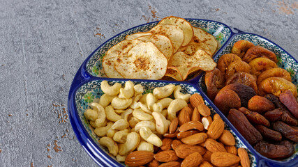 Decorative bowl with variety of dry fruits and nuts healthy snacks.