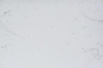 Aged white wall with cracks scratches and black brush strokes dirty old abandoned suburban texture