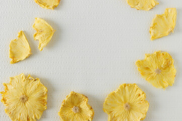 Texture of yellow fruit dried pineapple slices. Juicy close-up abstract background.