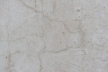 Grey texture of old broken asphalt road or wall big abrasions cracks holes on the surface pebbles cement in Sofia, Bulgaria, Eastern Europe