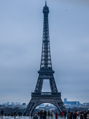 Fototapeta na wymiar Paris. Eiffel Tower In Paris. Looking Up At The Famous Iron Tower In Paris, Against A Gray Cloudy Sky. Travels