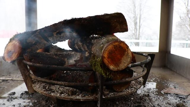 Campfire burns in the snowy day. Tufandag Resort. Hiking Tourism in Gabala - Azerbaijan.