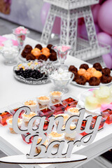 Children's birthday. The festive table is decorated for the reception of the guest. There are a lot of sweets on the table. Compote, jelly, muffins and fruits.