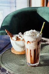 Cocoa with cream in glass beaker.Hot drink with whipped cream.