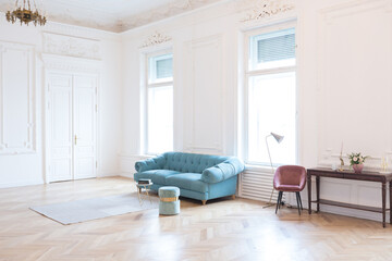 chic spacious light room in an old mansion in the classical style of the 19th century with a high ceiling decorated with stucco on white walls
