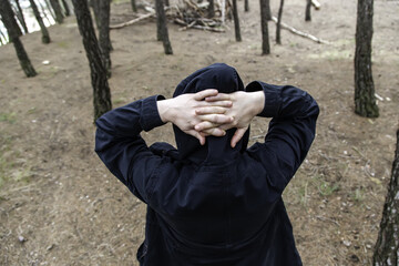 Hooded person in forest