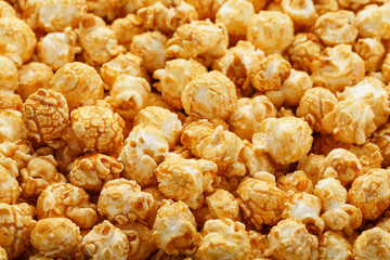 Popcorn in caramel glaze close-up as a background.