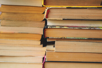 Chaotic stack of old books background, filter applied. Book texture background. Concept eduction. Background from old books that are exhibited in a chaotic manner