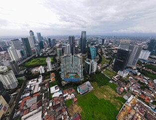 Fototapeta na wymiar Aerial view of bellagio boutique mall building in Jakarta and noise cloud with cityscape. the largest building center in Jakarta. JAKARTA - Indonesia. February 4, 2021