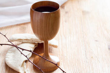 Chalice of wine, passover bread, thorns as Jesus Last Supper and Passion of Christ concept