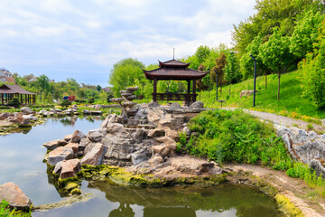 Fototapeta na wymiar Beautiful japanese gazebo by a pond in Japanese garden