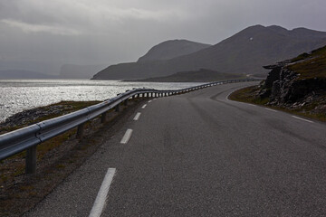 The twisting road along the Barents sea coast to the North Cape, Finnmark. Bad weather, the short polar summer in Northern Norway.