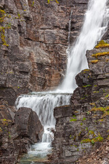 Towering waterfall falling from the rock, Finnmark, northern Norway. Shot at long exposure