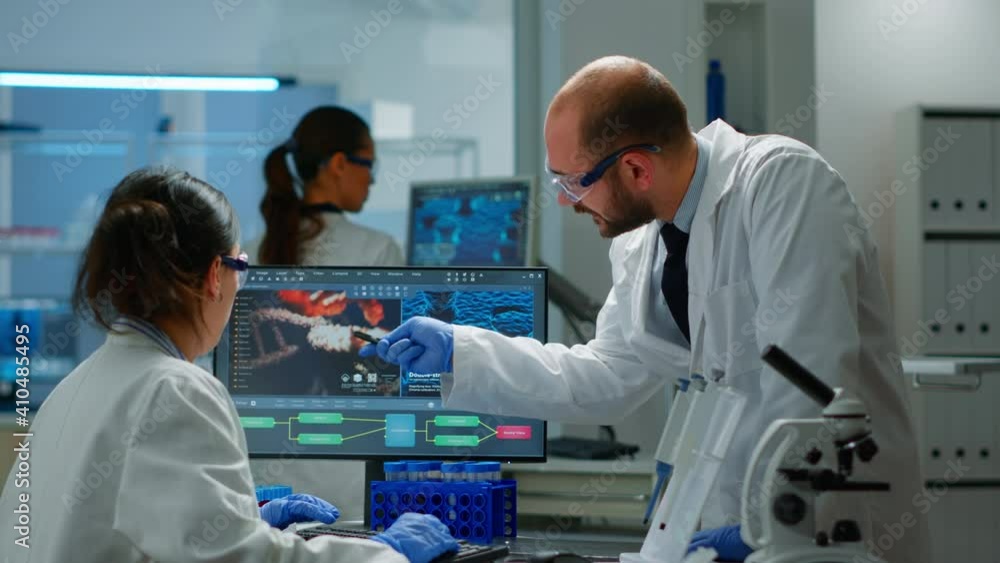 Aufkleber team of scientists worried about virus evolution discussing in equipped laboratory pointing at compu