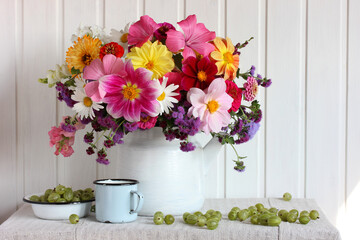 bouquet of garden flowers and gooseberries. dahlias, daisies, snapdragons and other flowers.