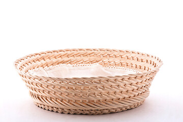 Empty wicker basket with cloth napkin, isolated on white background