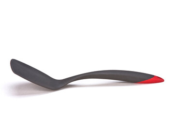 Dark gray with red plastic kitchen spatula, isolated on white background