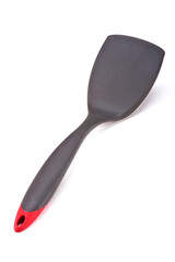 Dark gray with red plastic kitchen spatula, isolated on white background