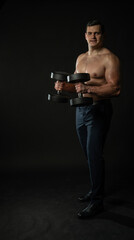 Man in trousers with dumbbells confident fashion, attractive background. Elegant models, successful lonely black bodybuilder background