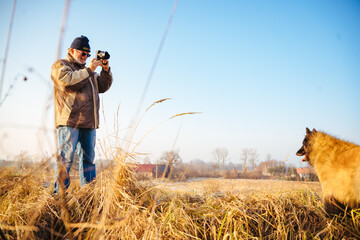 Man taking photo of dog