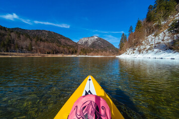 Stand up paddling through icy mountain lake