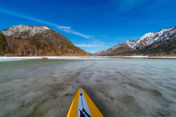 Stand up paddling through icy water