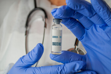 medicine vaccine in a bottle in the doctor's hand for coronavirus pneumonia disease