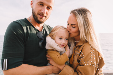 Mother, dad and daughter on the sea.