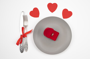  Marriage proposal and engagement concept. Table setting for Valentine's day, romantic dinner. Vintage tableware with red engagement ring box on white table