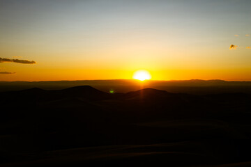 Orange horizon sunset over sandy dunes in great sand dunes national park in ameika