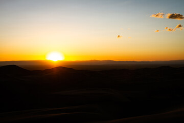 Orange horizon sunset over sandy dunes in great sand dunes national park in ameika
