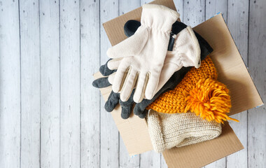 donations to the needy, warm clothes in a cardboard box