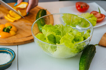 Plate with fresh salad leaves in a glass plate.