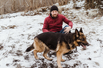 Owner man having fun with best friend german shepherd.